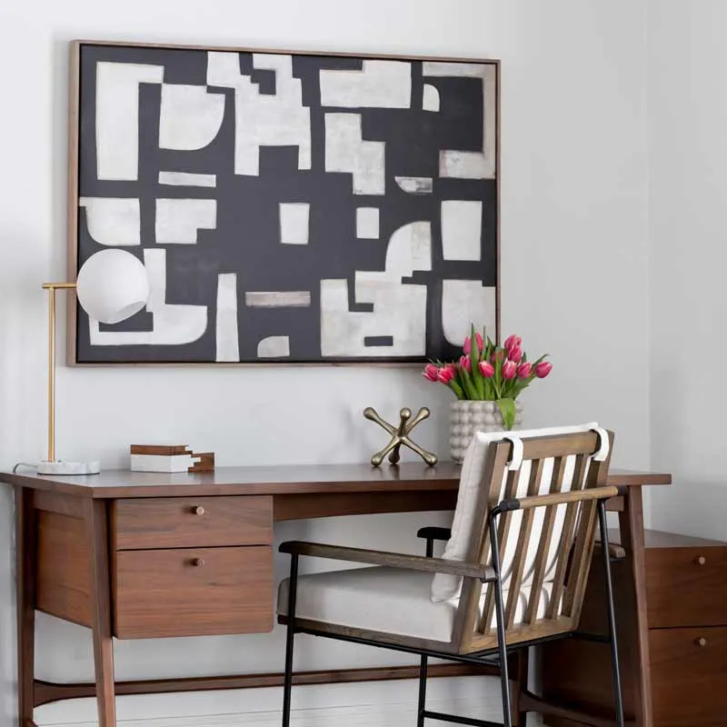 Styled home office desk with abstract artwork and decorative accents for furnishings and styling services